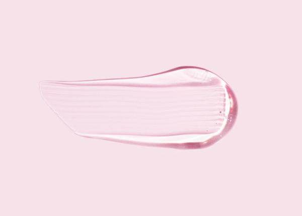 A clear swatch of hyaluronic acid gel on a pale pink ground