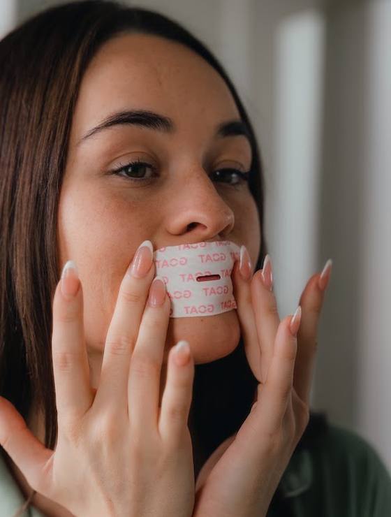 Pressing the tape onto her lips